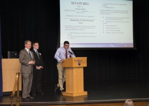 Students debate school property tax reform during a student government seminar hosted by Senator Argall, left. Blue Mountain’s Jack Barton, right, and Mahanoy Area’s Darryl Andreas, center, discuss a proposal to eliminate school property taxes. 