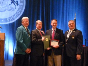 Thomas Gramling, Board of Directors for the Pennsylvania State Association of Boroughs, left; Senator Argall, second from left; and PSAB President Jack J. Lawyer, right; present Tamaqua Borough Councilman Micah Gursky with the “Council Member of the Year” award during the Association’s annual meeting in Hershey on Tuesday. 