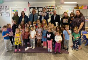 A picture of Senator Dave Argall and Rep. Tim Twardzik (R-123) at the Doodle Bug Preschool and Daycare with a group of teachers and students.