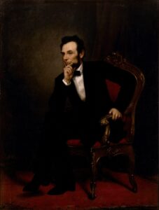 A painting of President Abraham Lincoln sitting in a chair looking onward
