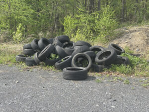 A picture of a pile of scrap tires along a bike path in Coaldale.