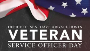 The words “Office of Sen. Dave Argall hosts Veteran Service Officer Day” on a gray background with an American flag.