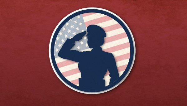 A silhouhette of a woman armed services member saluting in front of an American flag.