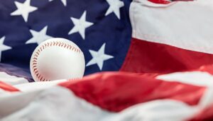 A picture of US Flag and baseball.