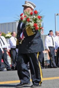 A picture of Bruce Berger marching in a parade.