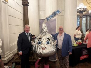 A picture of Senator Argall with Miss Kiss, a character from Hershey Foods, at the State Capitol.