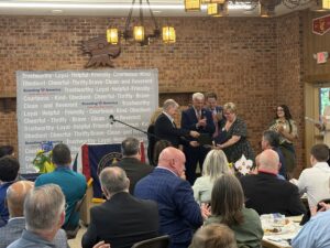 A picture of Sen. Argall presenting Kelly Malone with a congratulatory citation.