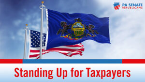 American flag flying behind the Pennsylvania flag with the words Standing Up for Taxpayers underneath.