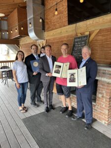 A picture of Senator Argall and Rep. Dane Watro presenting citations to Cusat’s Café as they celebrate 90 years in business.