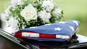 A picture of a US flag placed on top of a casket.