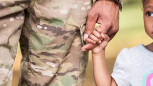 A picture of a service member with their child.