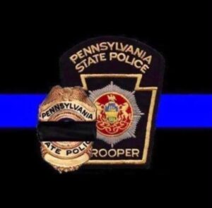 Pennsylvania State Police Trooper badge with the blue line behind and a black line in front.