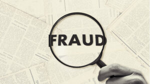 magnifying glass zooming in on the word “fraud.”