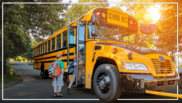 a child getting on a school bus.