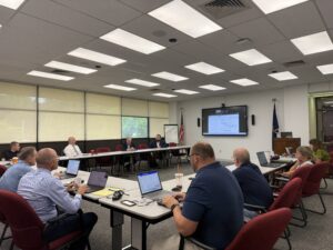 A picture of Senator Argall speaking with local superintendents.