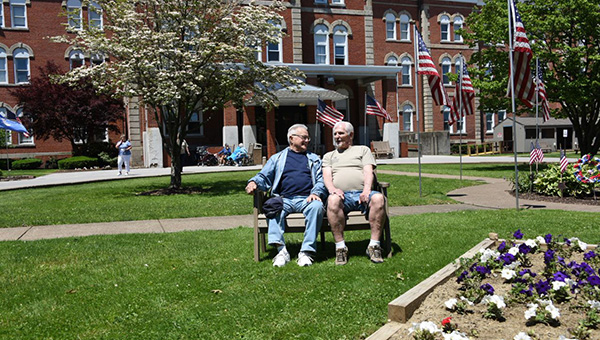 two men sitting on a bench.